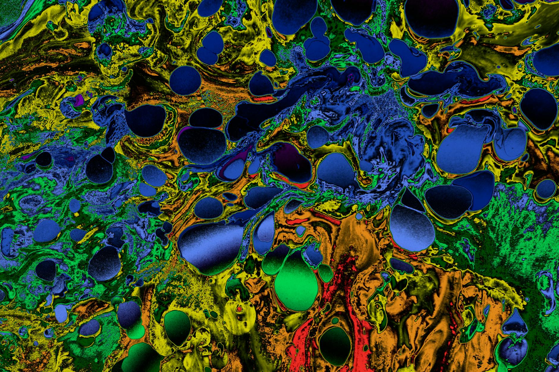Dynamic abstract image featuring vivid multicolored swirls with a mix of blues, greens, and yellows.
